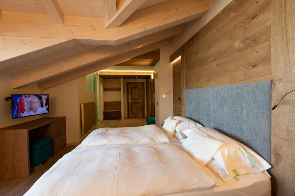Postel nebo postele na pokoji v ubytování Hotel Cervo