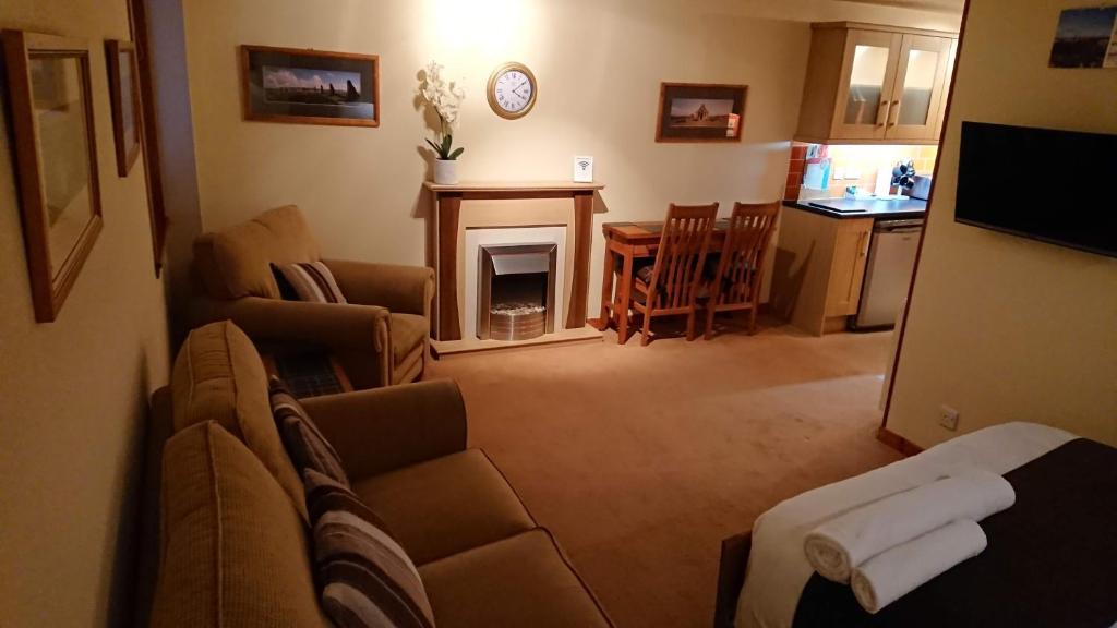 a living room with a couch and a fireplace at Castleyards Apartment 12 in Kirkwall