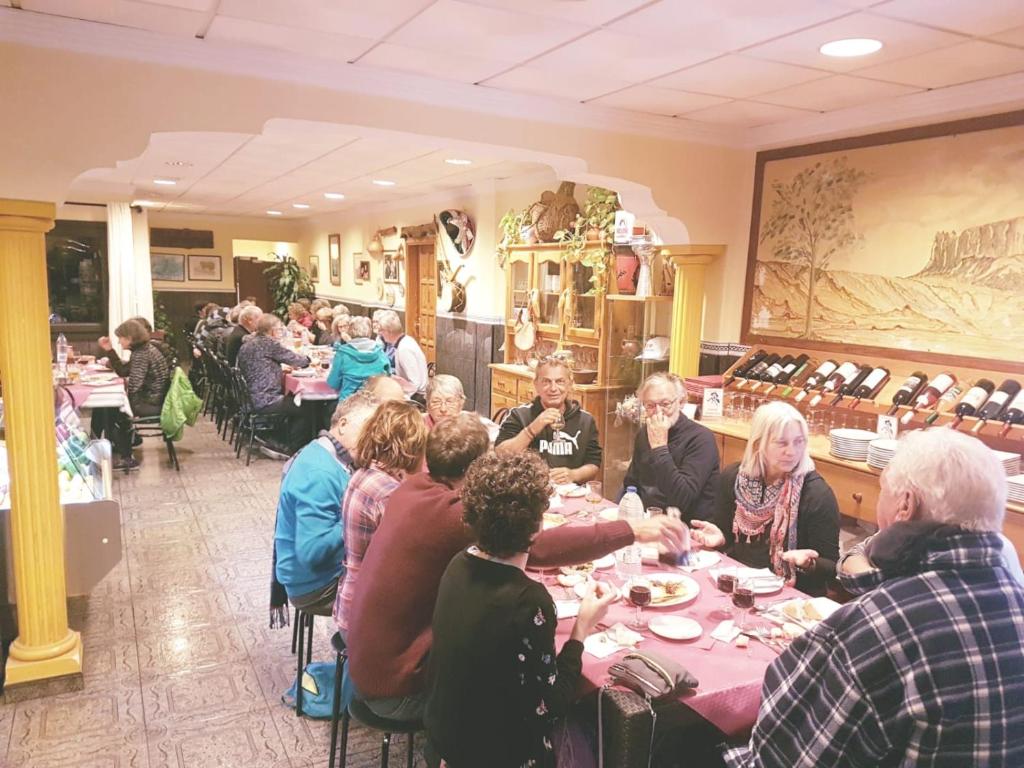 a group of people sitting at tables in a restaurant at Hotel Sonia Chipude in El Cercado