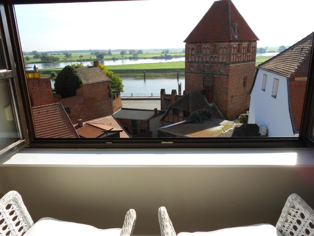 a room with a window with a view of a building at Ferienhaus Elbblick in Tangermünde