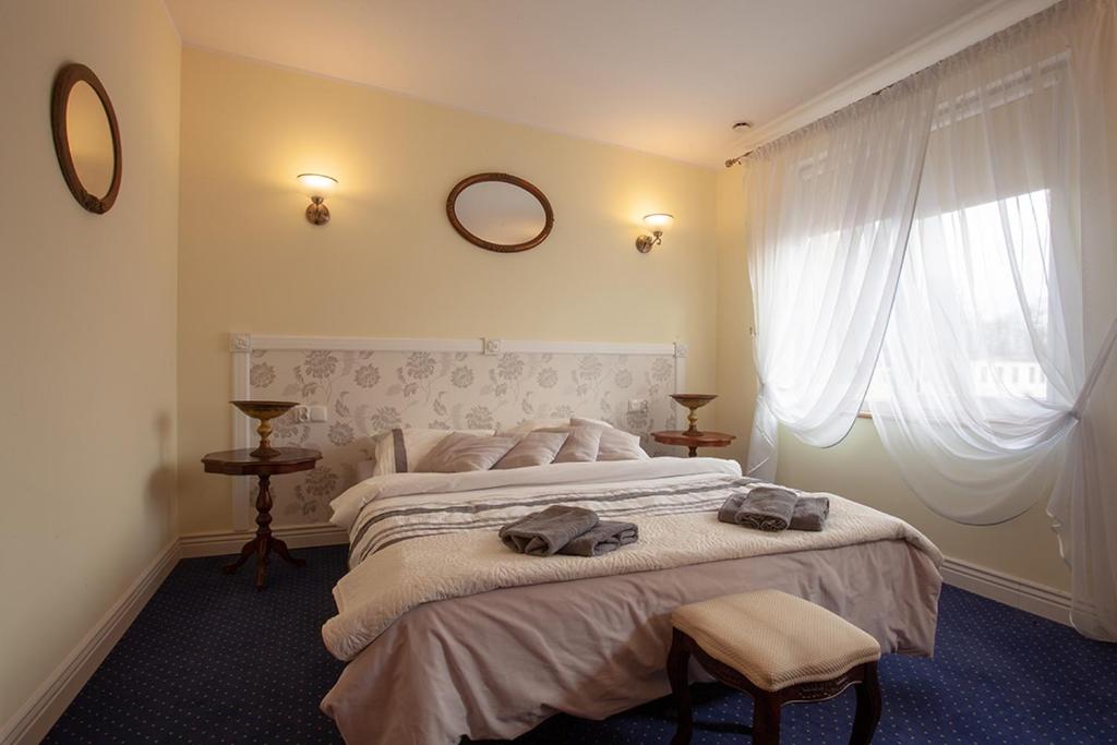a bedroom with a large bed with two bags on it at Napoleoński in Legnica