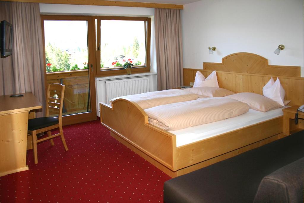 Postel nebo postele na pokoji v ubytování Hotel Hochland