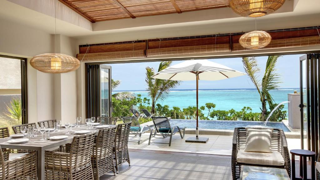a dining room with a view of the ocean at Stylia Villas in Trou d'Eau Douce