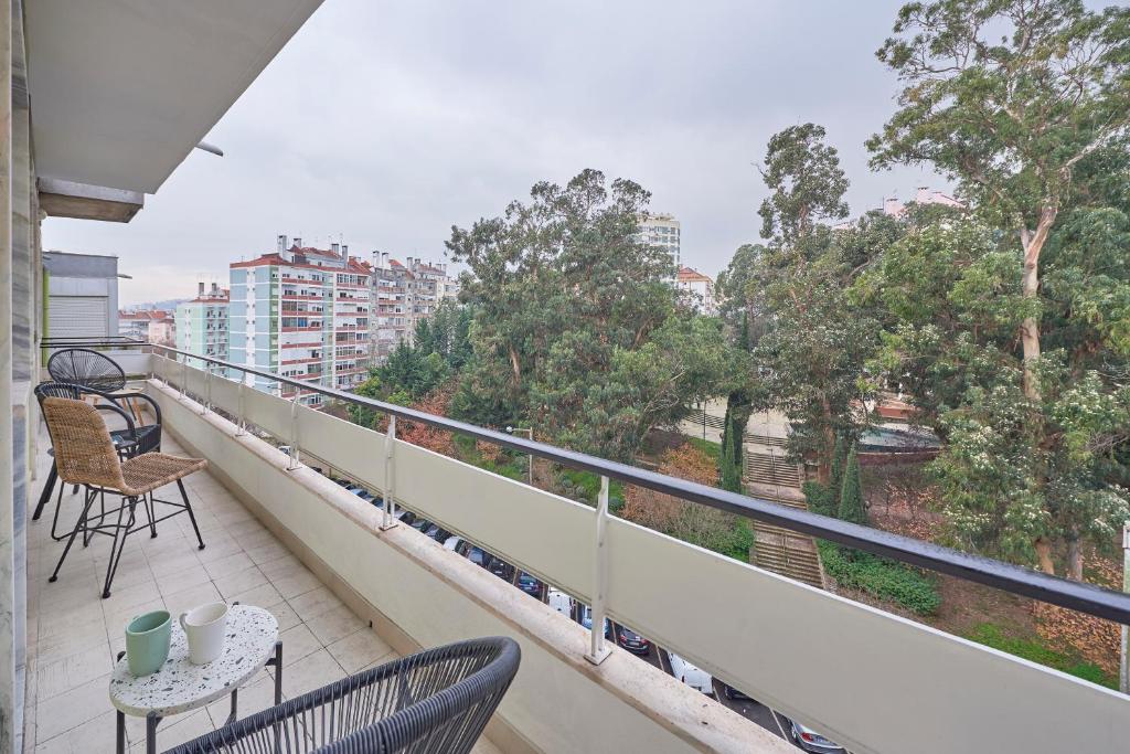 a balcony with chairs and a table with a view at Light Apartment With Amazing Balcony, by TimeCooler in Lisbon