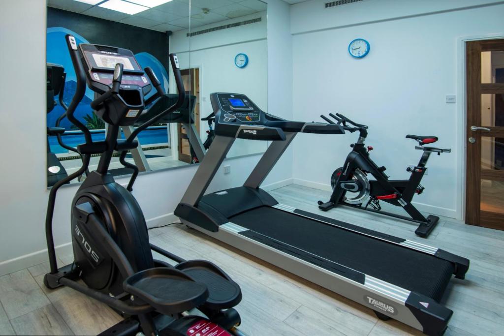 a gym with two exercise bikes and a treadmill at Wessex Hotel in Street