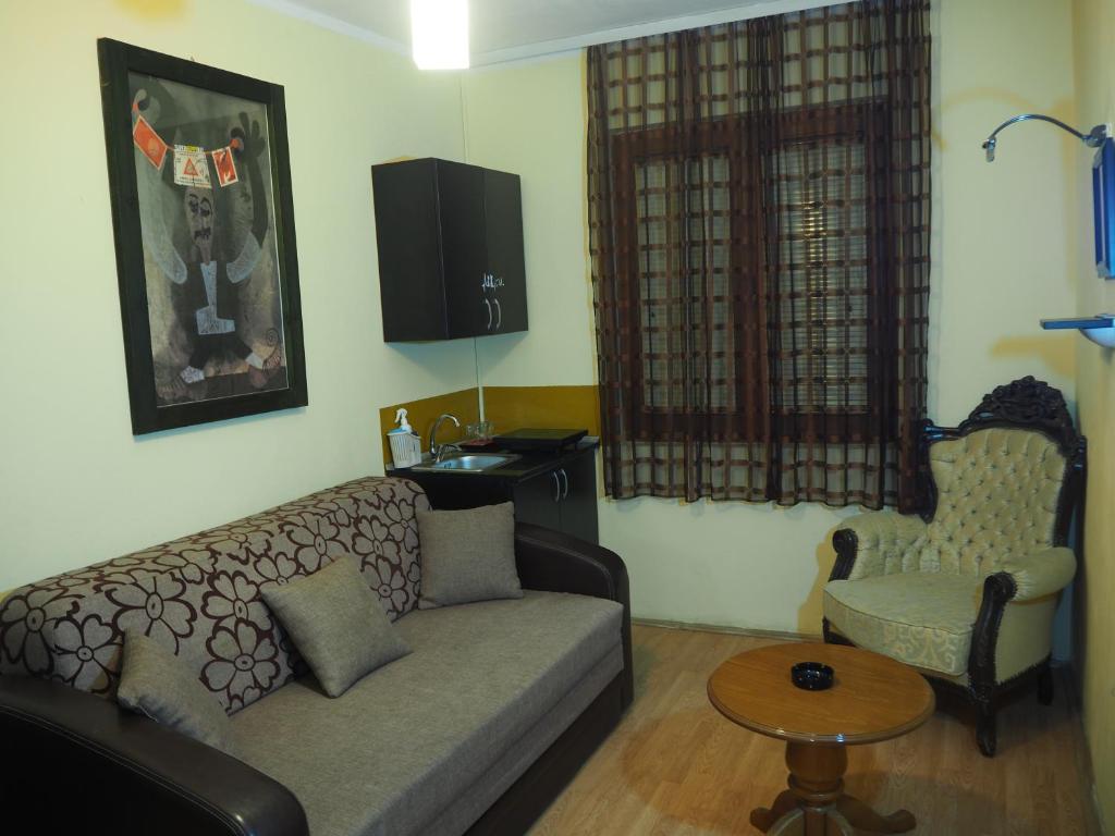 a living room with a couch and a table at Hostel Kosmopolit in Niš