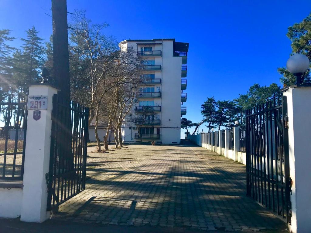 a fence in front of a building with a building at Kobuleti Rooftop Hotel in Kobuleti