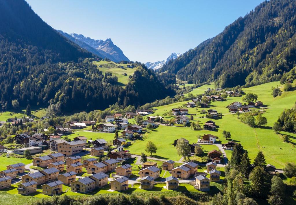 an aerial view of a village in the mountains at Chalet-Resort Montafon in Sankt Gallenkirch