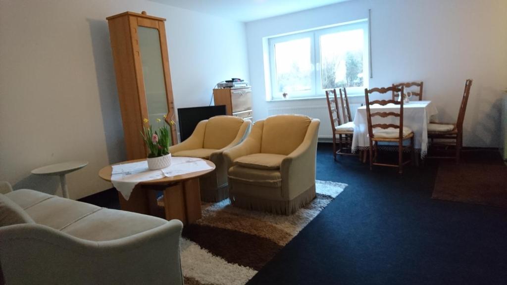a living room with couches and chairs and a table at Ferienwohnung am Waldchen in Bad Kissingen