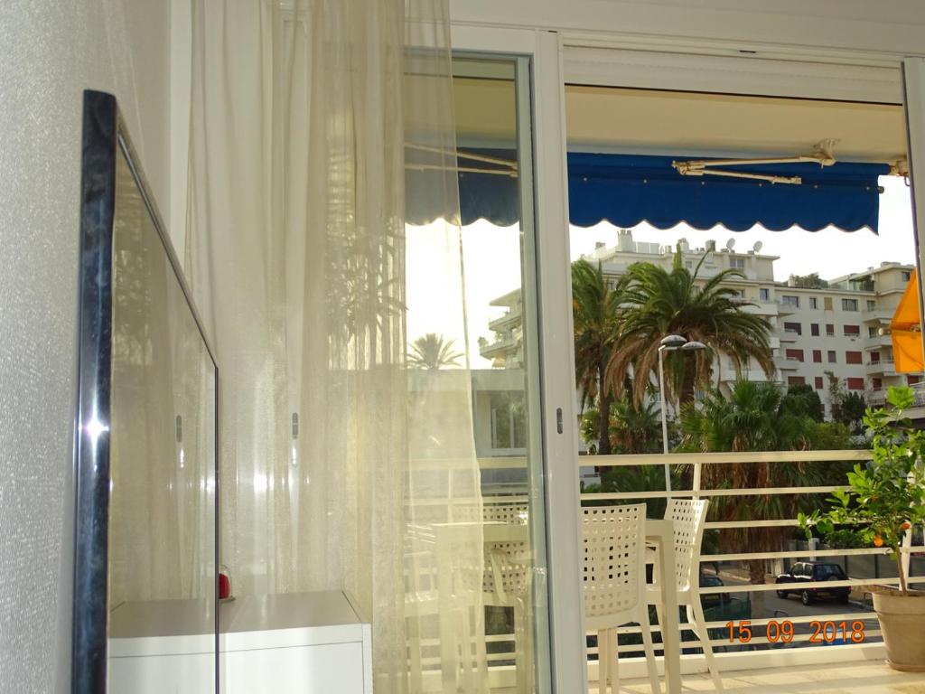 a sliding glass door with a view of a balcony at Palm beach Cannes Azur in Cannes