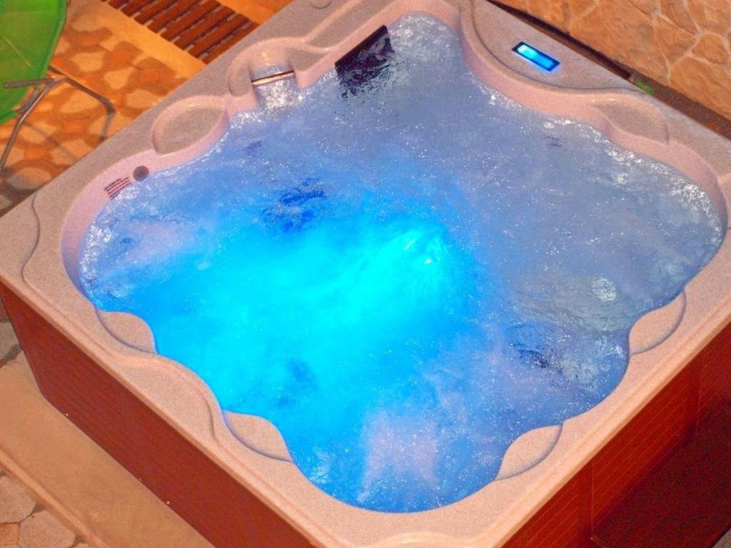 a hot tub with blue water inside of it at House Goran in Kolan