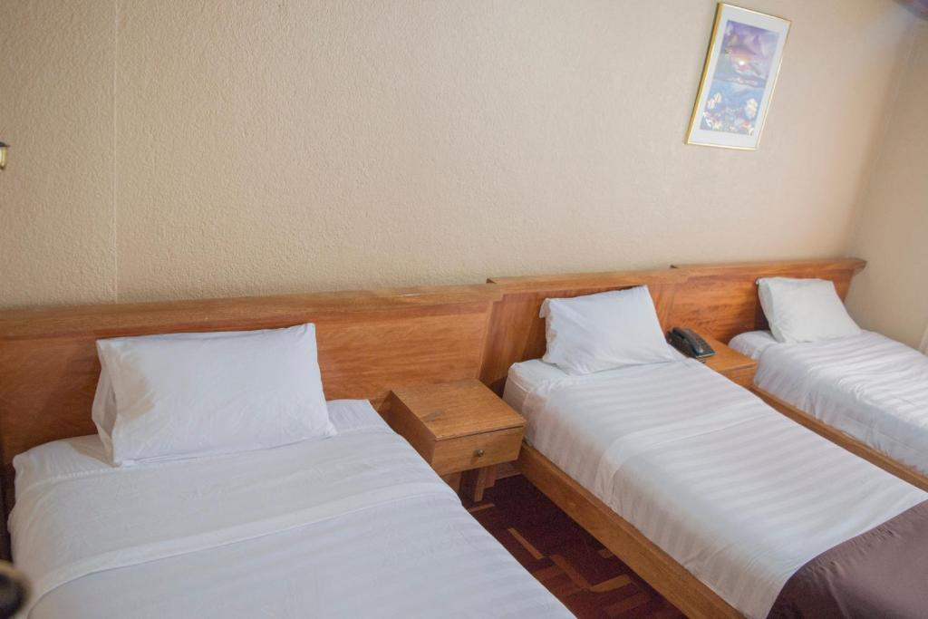 Postel nebo postele na pokoji v ubytování Hostal Loro Verde