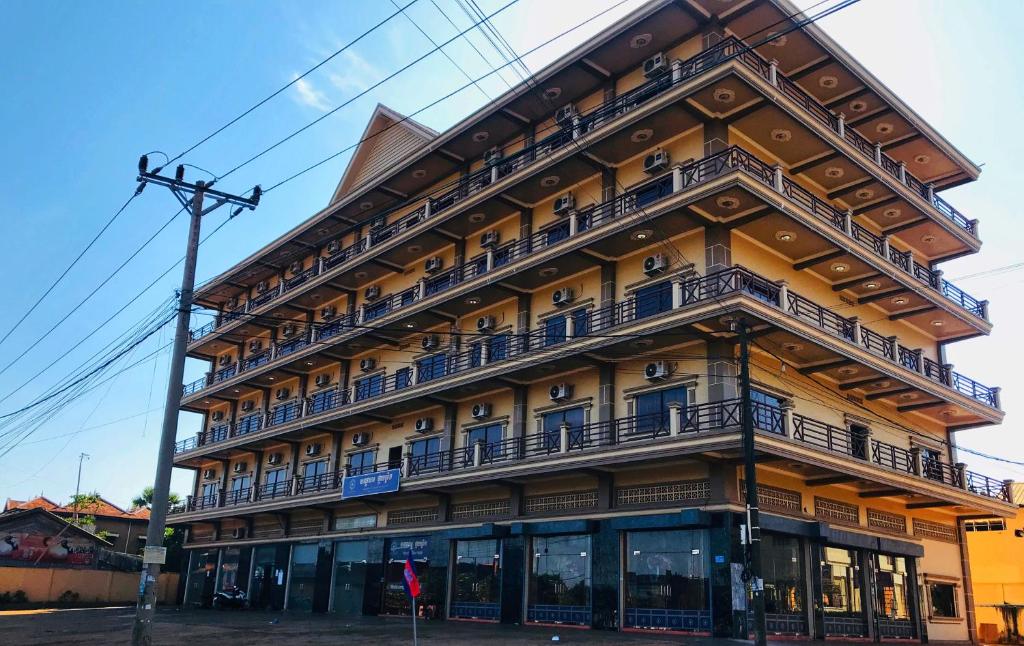 a large building with balconies on the side of it at Morning Star Hotel in Banlung