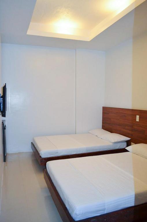 Letto o letti in una camera di Taj Guesthouse Boracay