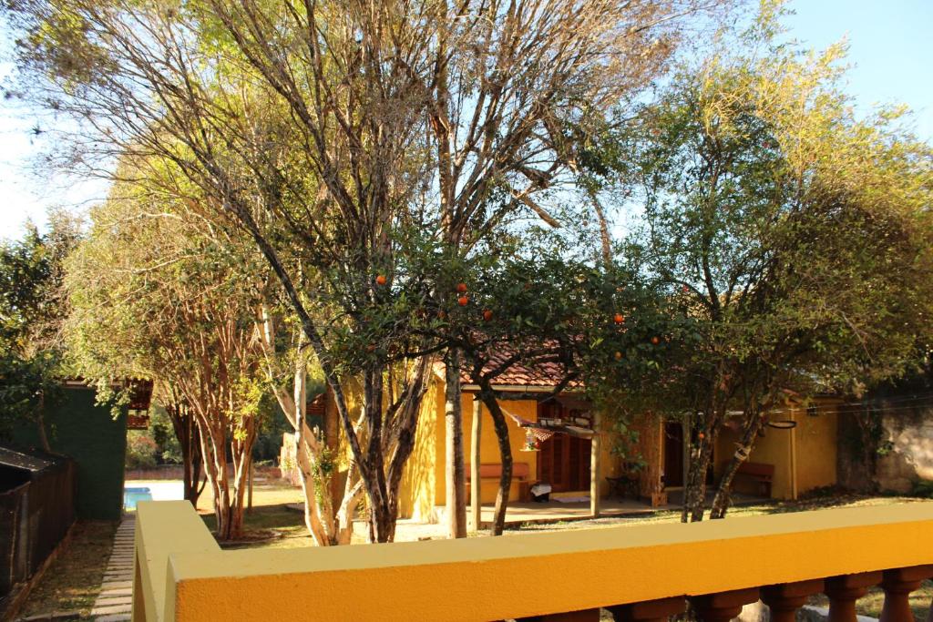 a yellow fence in front of trees and a building at Guappo Socorro in Socorro