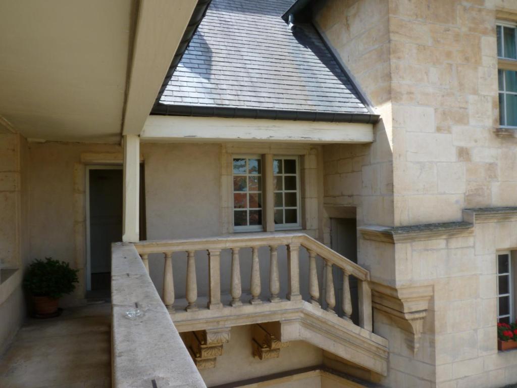 a house with a staircase on the side of it at Hotel D&#39;haussonville in Nancy