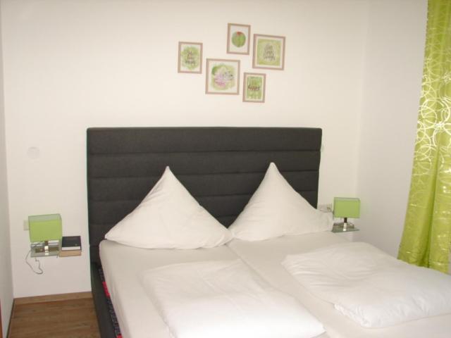 a bed with two white pillows on top of it at Gasthof Bräuhäusle in Baienfurt