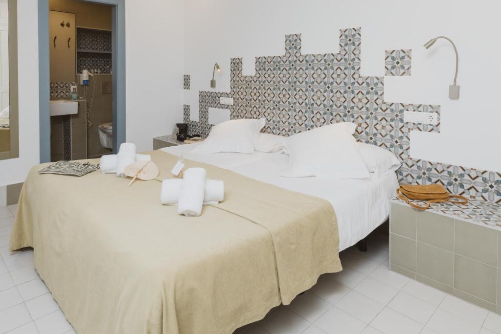 Postel nebo postele na pokoji v ubytování Hostal Gravina