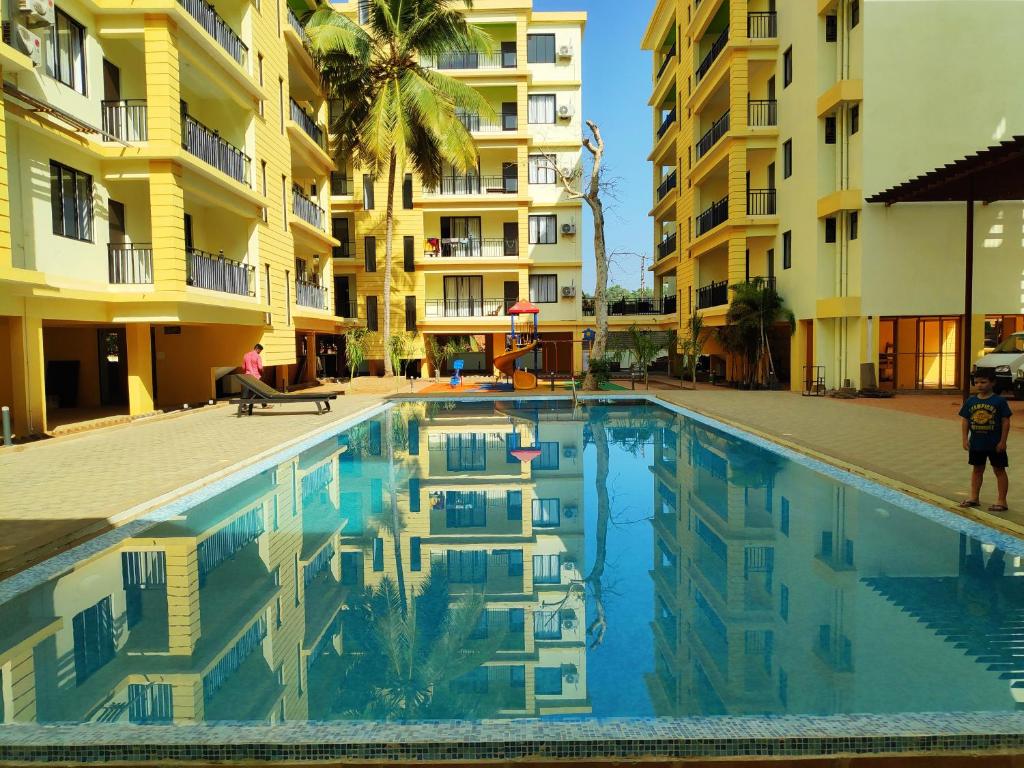 a swimming pool in front of a apartment building at Patnem Beach park in Canacona