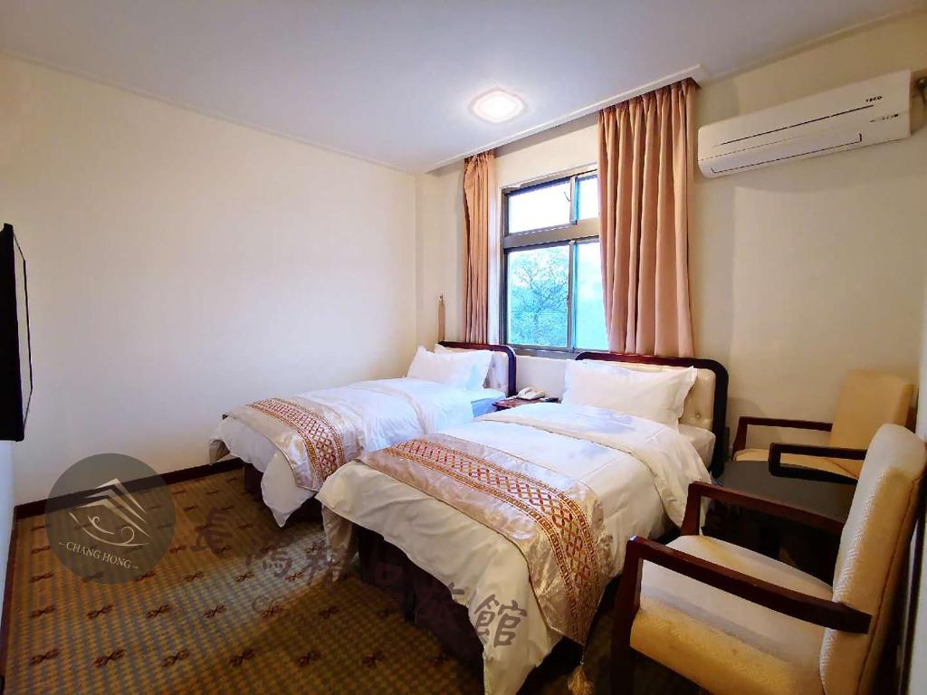 Postel nebo postele na pokoji v ubytování Chang Hong Hotel