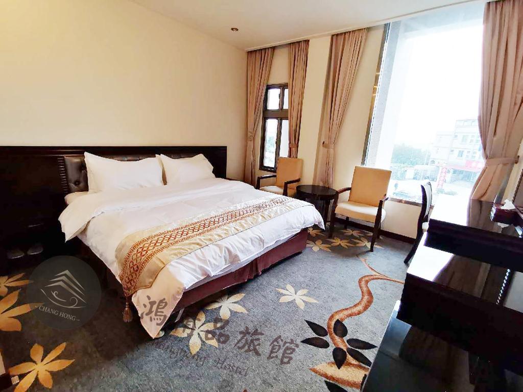 Postel nebo postele na pokoji v ubytování Chang Hong Hotel