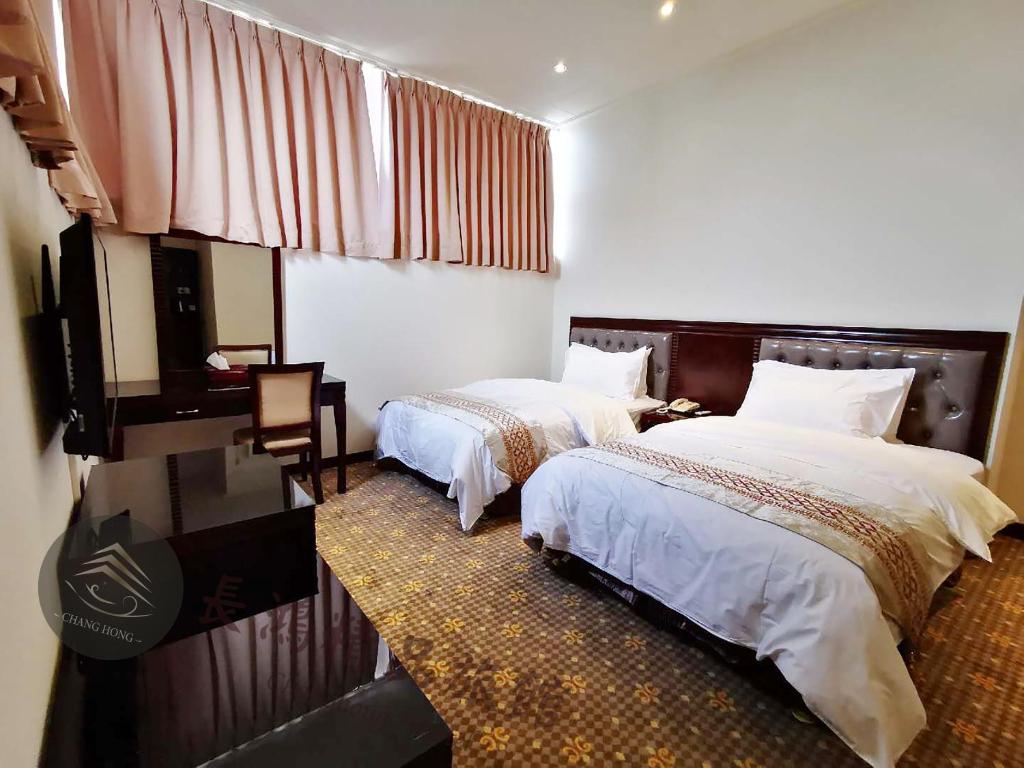 Postel nebo postele na pokoji v ubytování Chang Hong Hotel