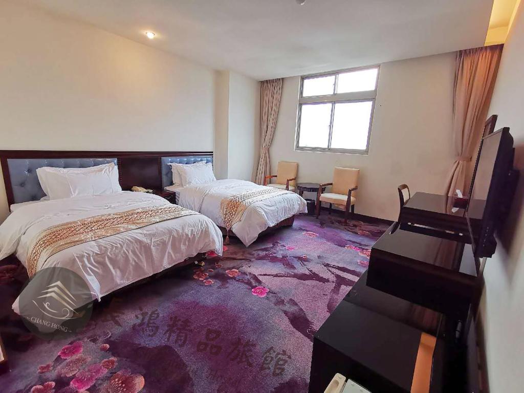 Postel nebo postele na pokoji v ubytování Chang Hong Hotel