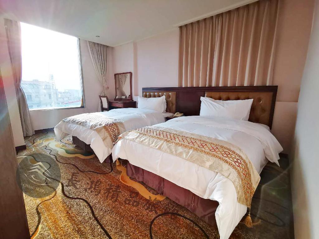 Postel nebo postele na pokoji v ubytování Chang Hong Hotel