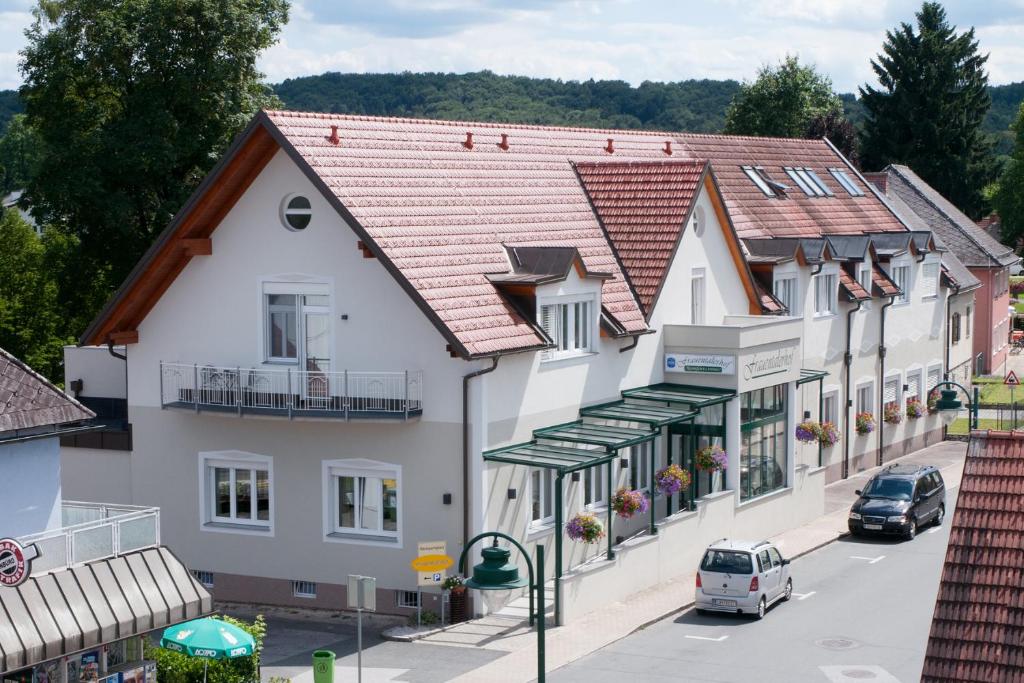 a building in a town with cars parked on the street at Frauentalerhof in Frauental an der Lassnitz 
