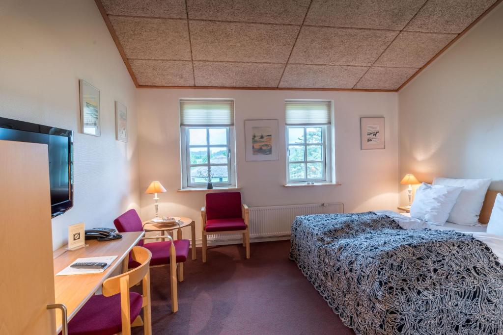 Postel nebo postele na pokoji v ubytování Vilcon Hotel & Konferencegaard