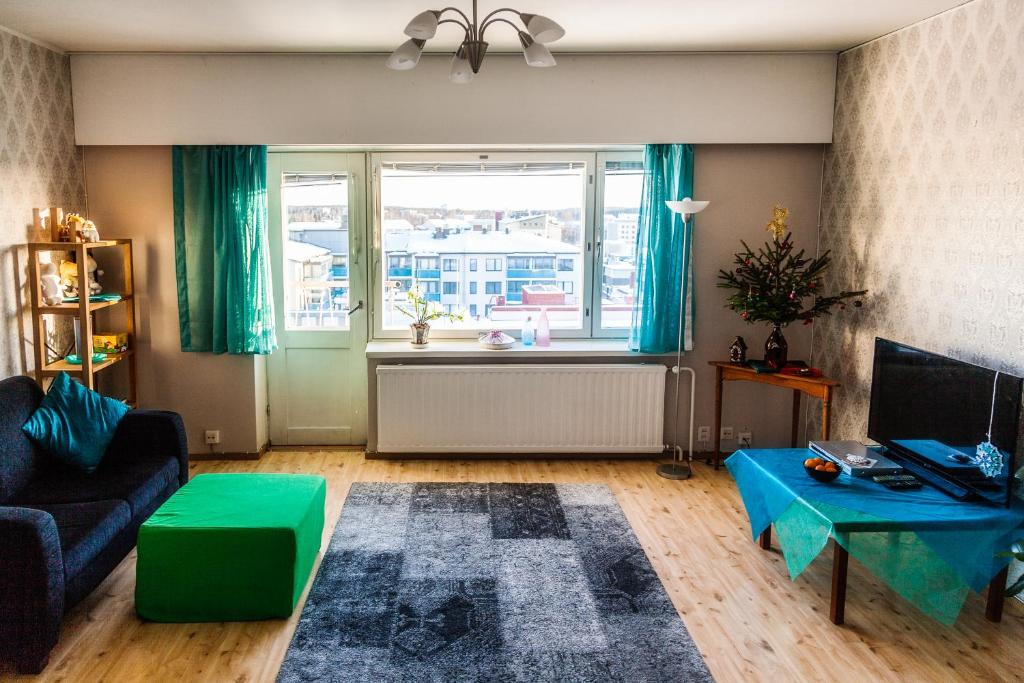 a living room with a couch and a window at Kouvola Apartment in Kouvola