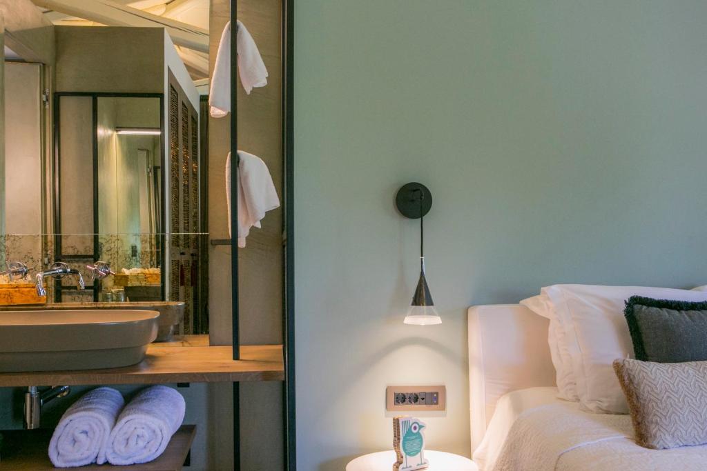 a bathroom with a sink and a mirror at Ekies All Senses Resort, a Member of Design Hotels in Vourvourou