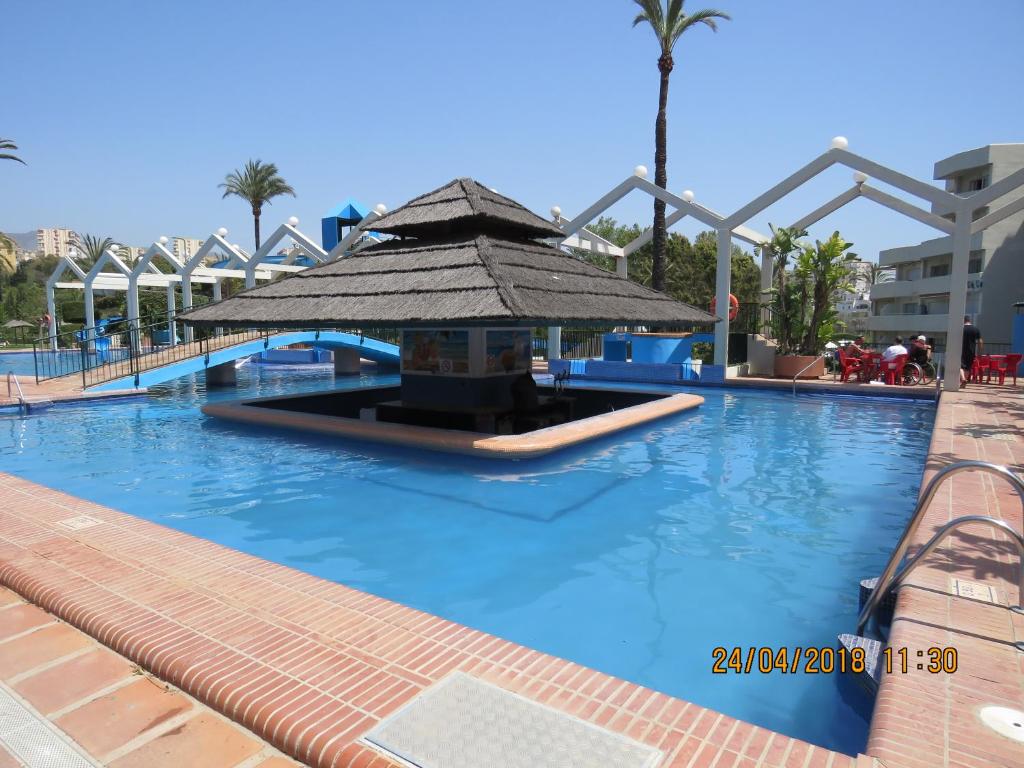 a pool at a resort with a large swimming pool at Benal Beach Apartments in Málaga