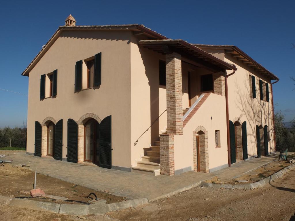 a house that is under construction on a street at Uliveta in San Gimignano