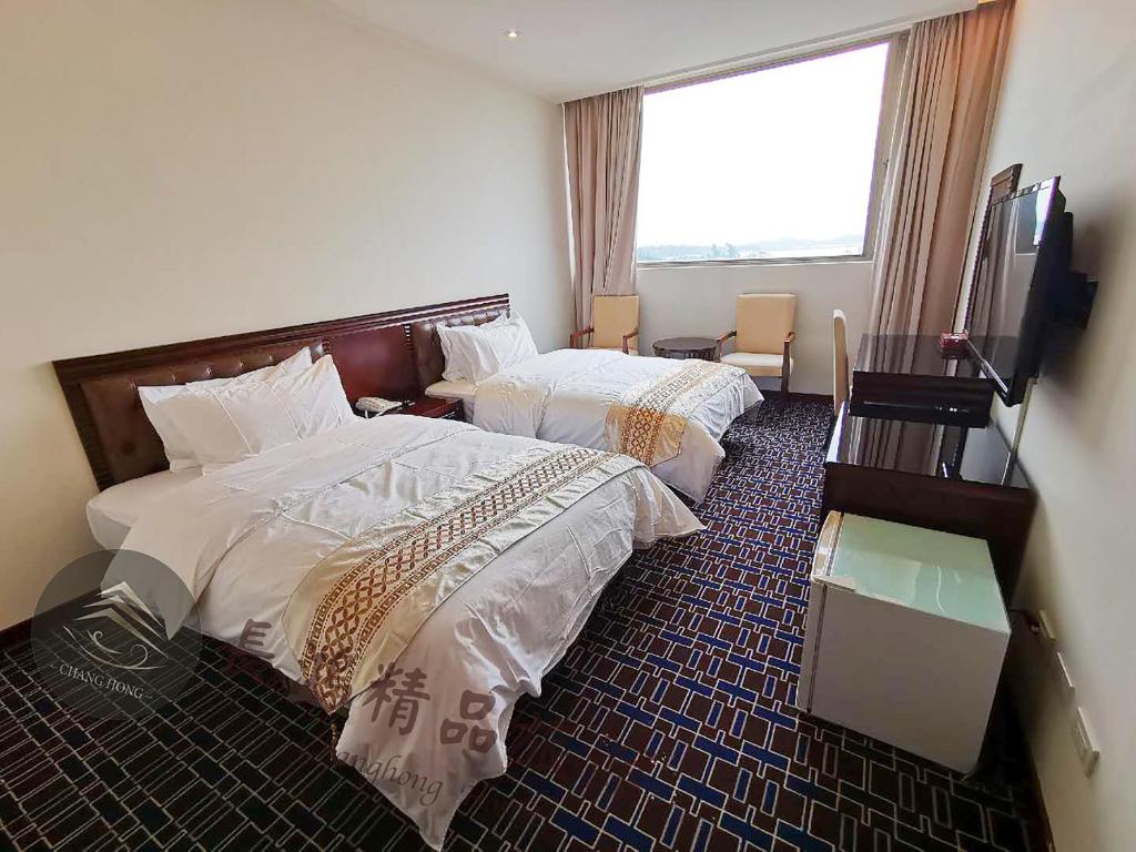 Postel nebo postele na pokoji v ubytování Chang Hong Hotel