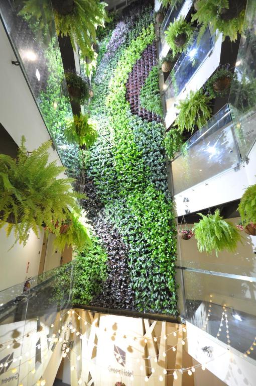 a vertical garden on the wall of a building with plants at Green Hotel - Fengjia in Taichung