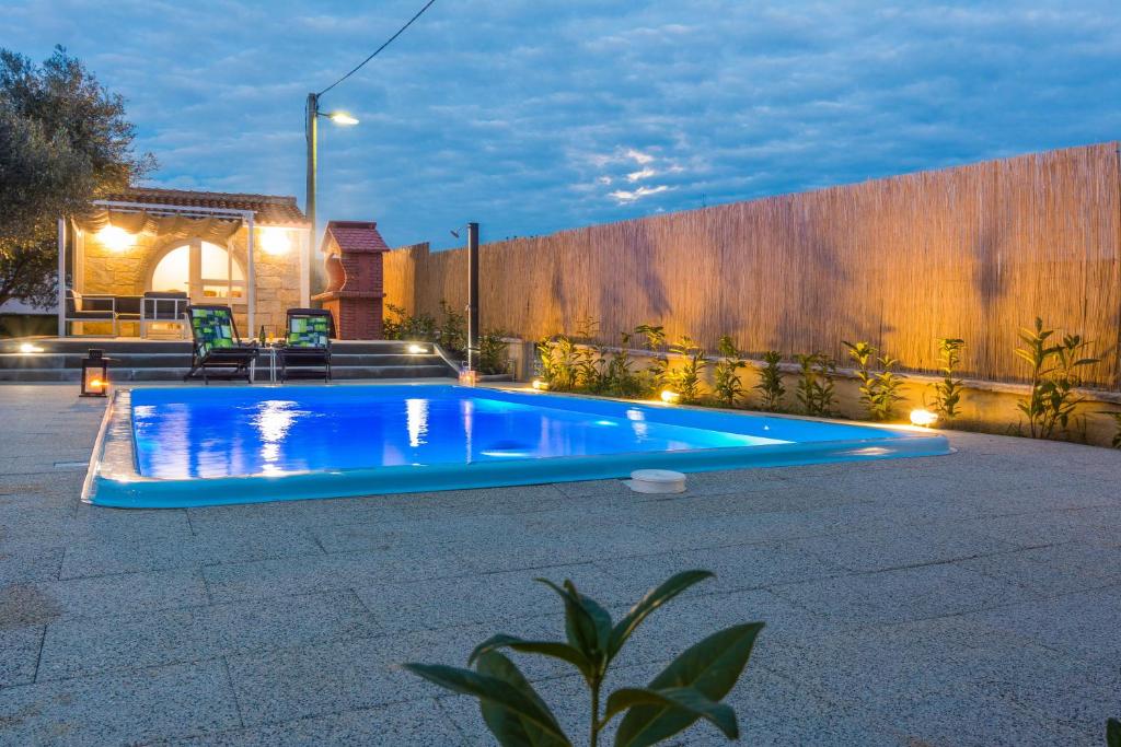 einen Pool im Hinterhof mit einem Zaun in der Unterkunft HOLIDAY HOUSE LAVANDA in Gornji Zemunik