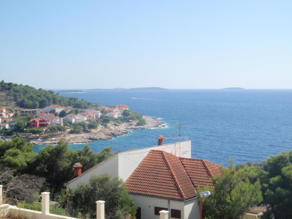 a house with a view of the ocean at Apartment Patricia in Primošten