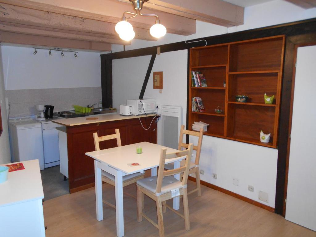 a kitchen with a table and chairs in a room at La cour des meuniers - le Froment et l&#39;Epeautre in Kaysersberg