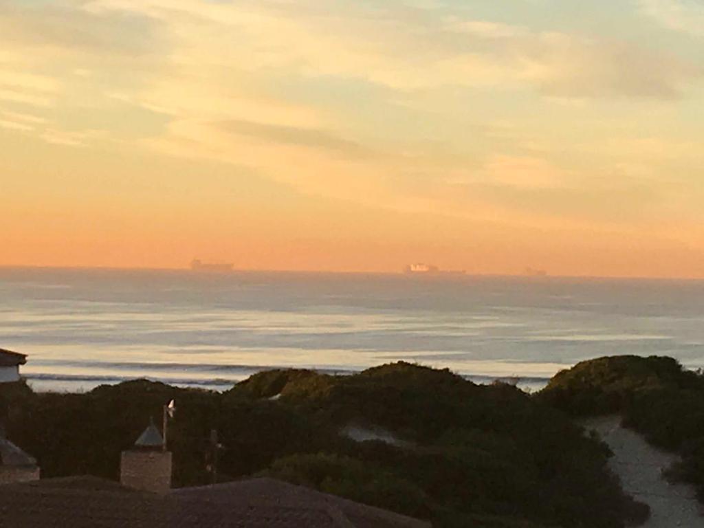 a view of the ocean from a beach at sunset at Nautilus Guesthouse in Port Elizabeth
