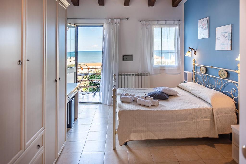 una camera con letto e vista sull'oceano di SCIUSCIA' ad Alcamo Marina