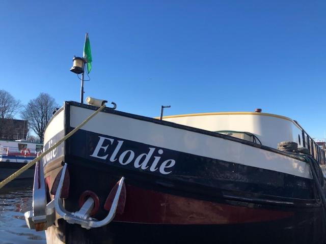 a boat with the word eclipse sitting in the water at Botel Elodie in Amsterdam