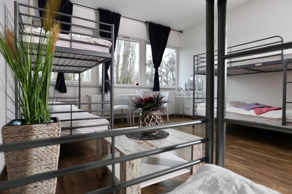 a dorm room with bunk beds and a table at Elsässer Hostel in Hamburg