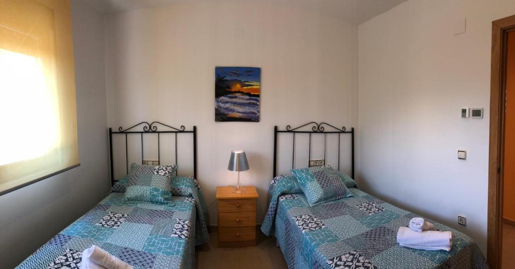 A bed or beds in a room at Casa Rural El Coscojar