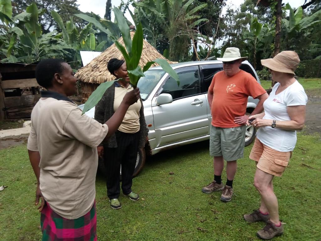 a group of people standing in front of a car at Machame Nkweshoo Cultural Tourism in Machame