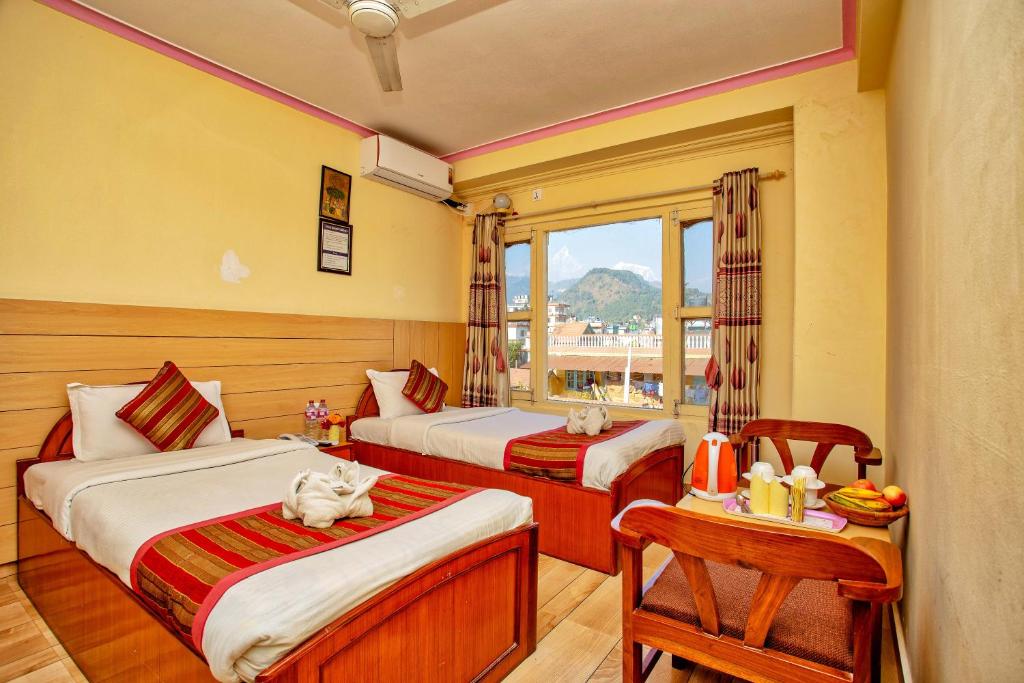 Postel nebo postele na pokoji v ubytování Hotel Grand Holiday