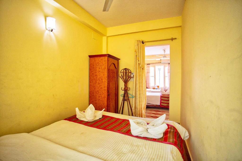 Postel nebo postele na pokoji v ubytování Hotel Grand Holiday