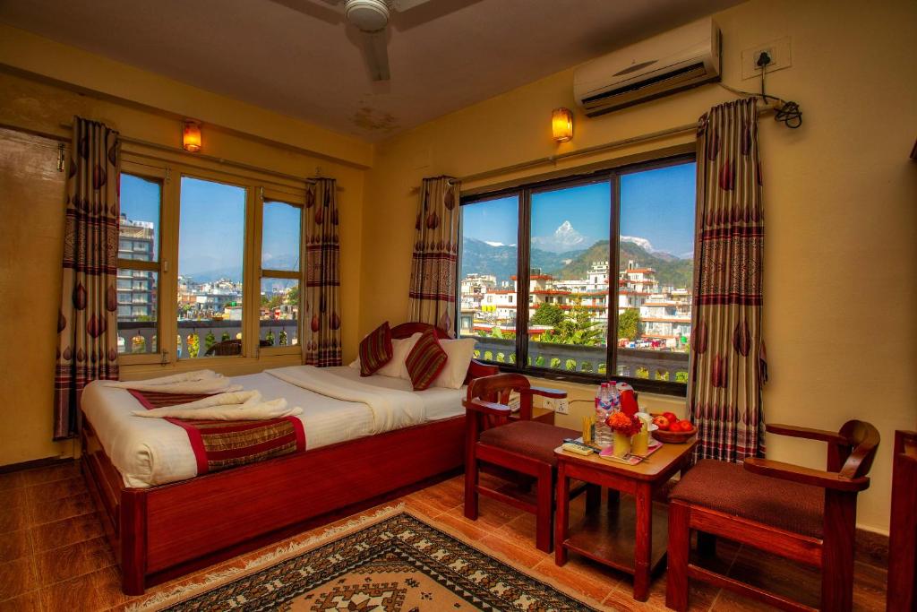 Postel nebo postele na pokoji v ubytování Hotel Grand Holiday