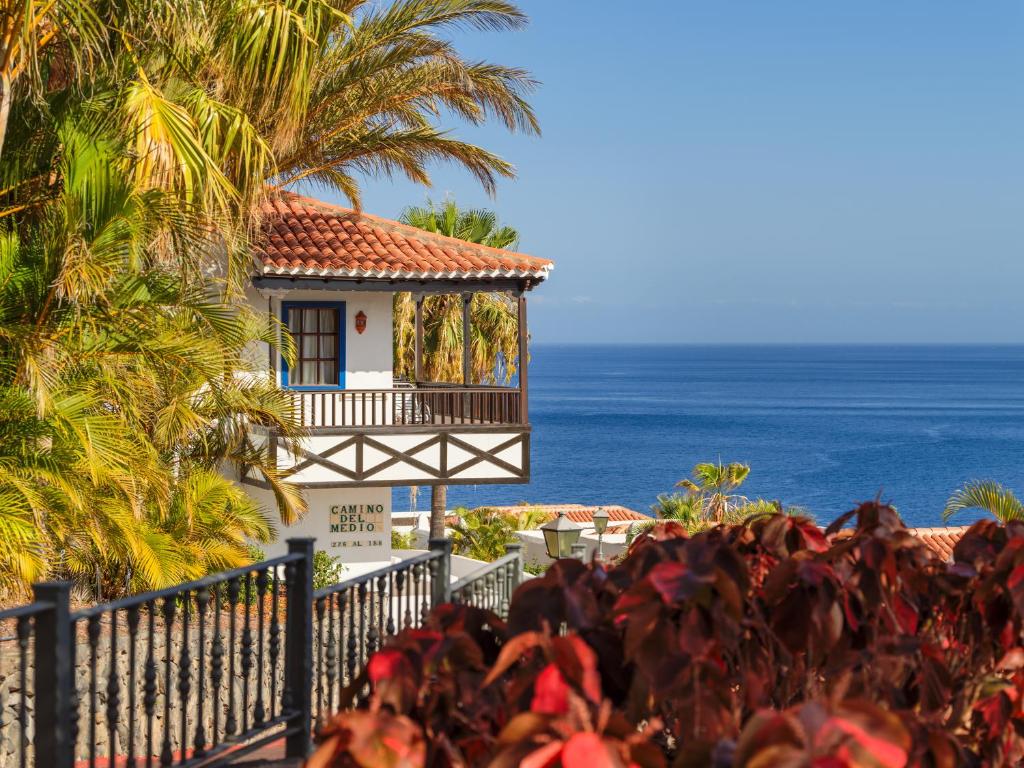 uma casa na praia com o oceano ao fundo em Hotel Jardín Tecina em Playa de Santiago