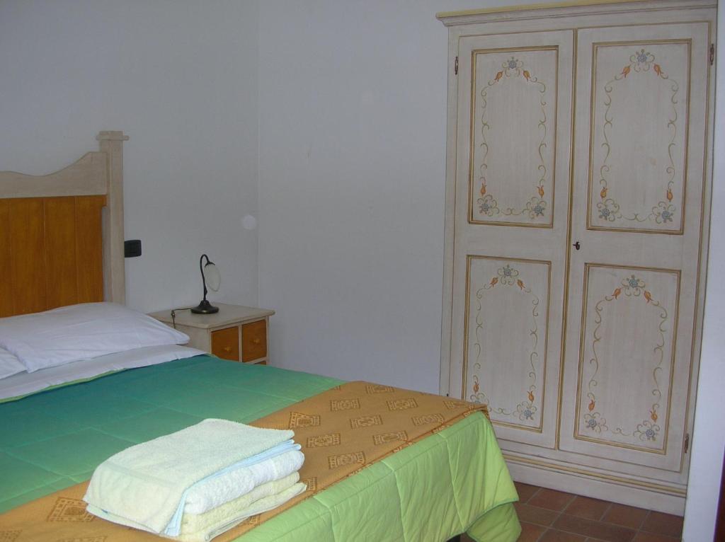 Postel nebo postele na pokoji v ubytování Agriturismo Roccagelli